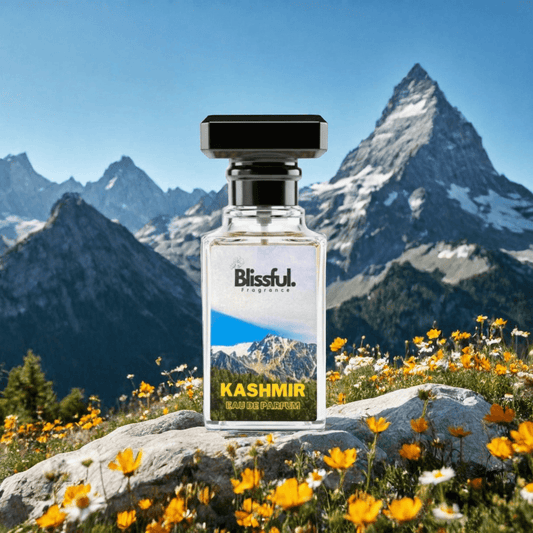 Blissful Kashmir Eau de Parfum bottle on rock with yellow flowers and snowy mountain backdrop