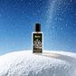 Blissful Millionaire perfume bottle on snow with sparkling particles and blue sky background