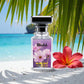Blissful Blue Lady eau de parfum bottle on sandy beach with tropical palm leaves and red hibiscus flower