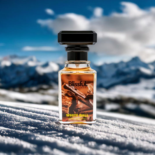 Blissful White Ball perfume bottle on snow with snowy mountains and blue sky background