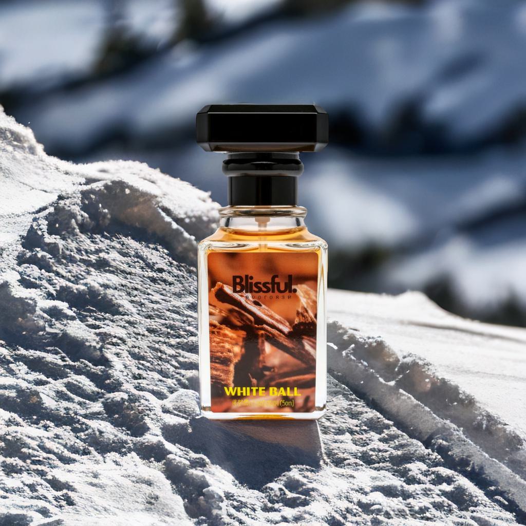 Blissful White Ball perfume bottle on snowy surface with blurred winter background