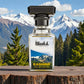 Blissful Kashmir Eau de Parfum bottle with snowy mountain and pine forest background