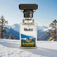 Blissful Kashmir Eau de Parfum bottle with snowy mountain background and pine trees