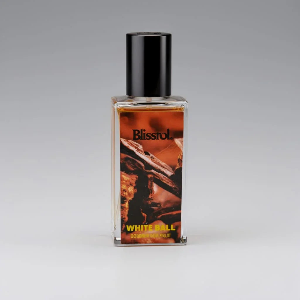 Blisstrol White Ball cologne bottle with black cap and orange label featuring wood design