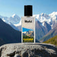 Blissful Kashmir Eau de Parfum bottle on stone with snowy mountain background and clear blue sky