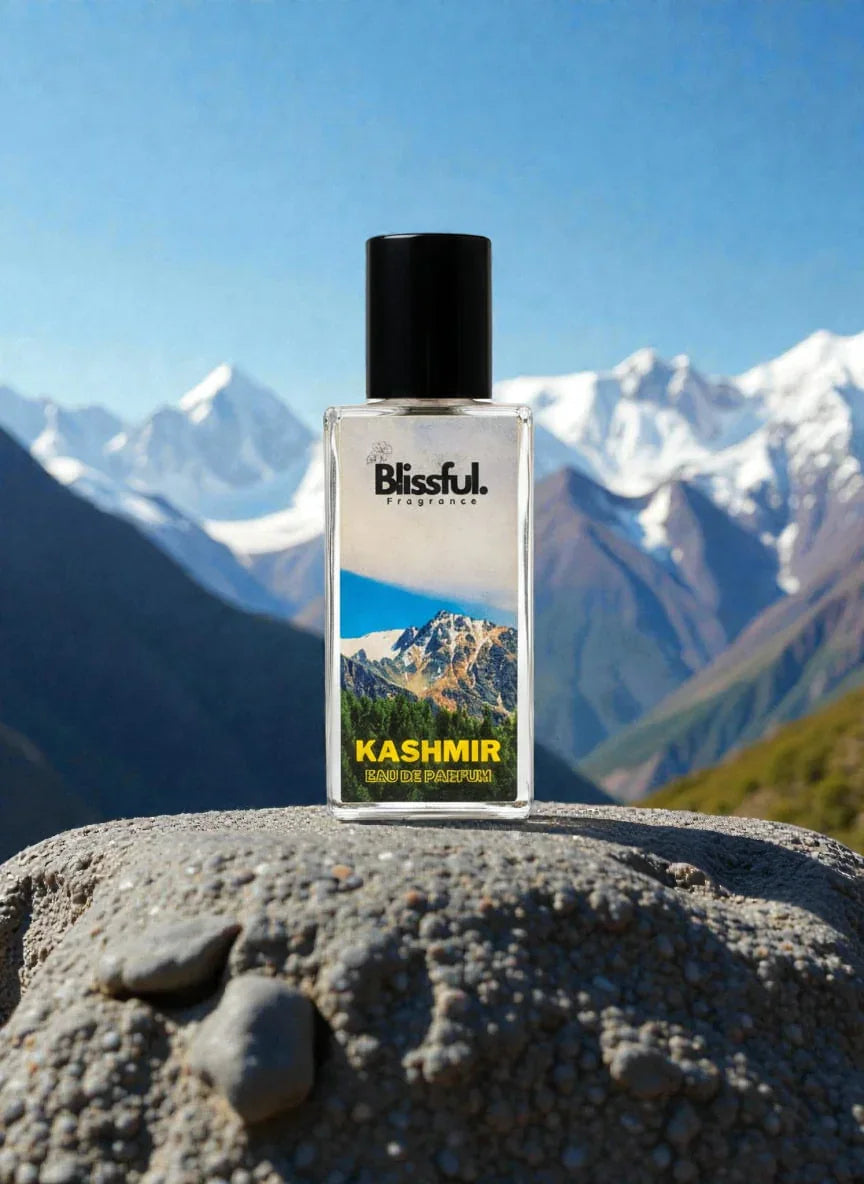 Blissful Kashmir Eau de Parfum bottle on stone with snowy mountain background and clear blue sky