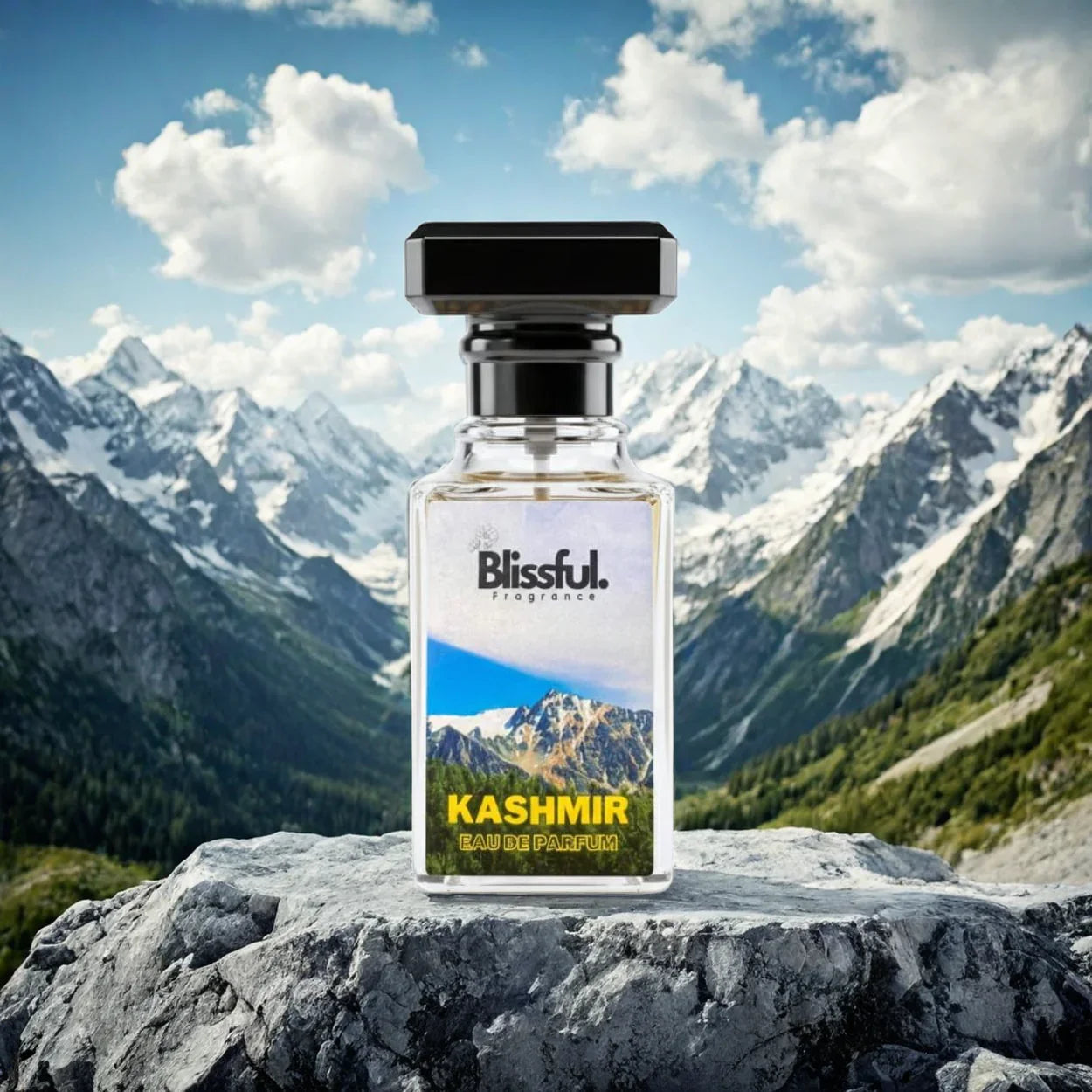 Blissful Kashmir Eau de Parfum bottle on rock with snowy mountain peaks and blue sky background